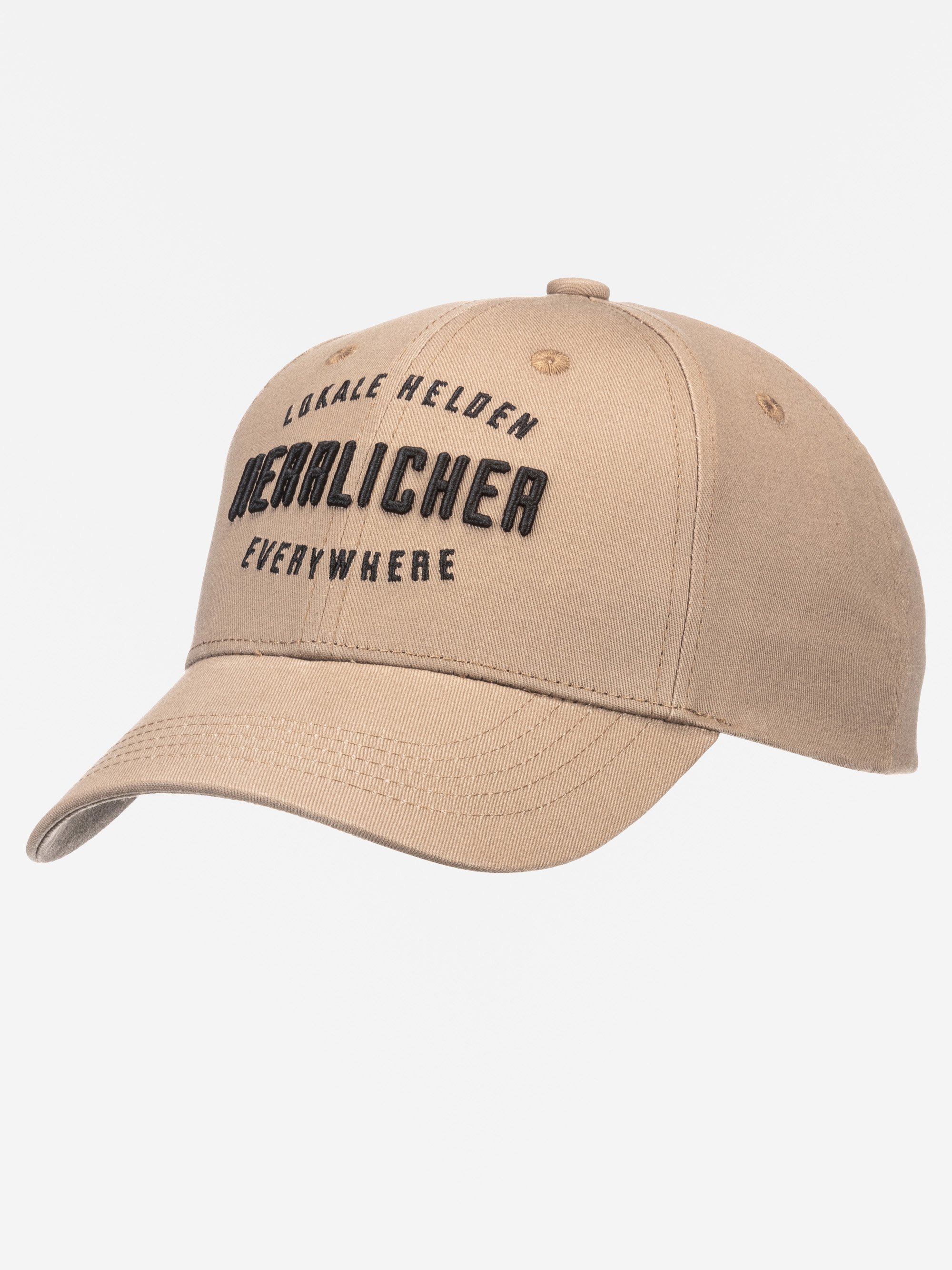 Eine beigefarbene Baseballkappe mit schwarzem gesticktem Text "LOKALE HELDEN DEURLOCHER EVERYWHERE" auf der Vorderseite vor einem schlichten weißen Hintergrund.