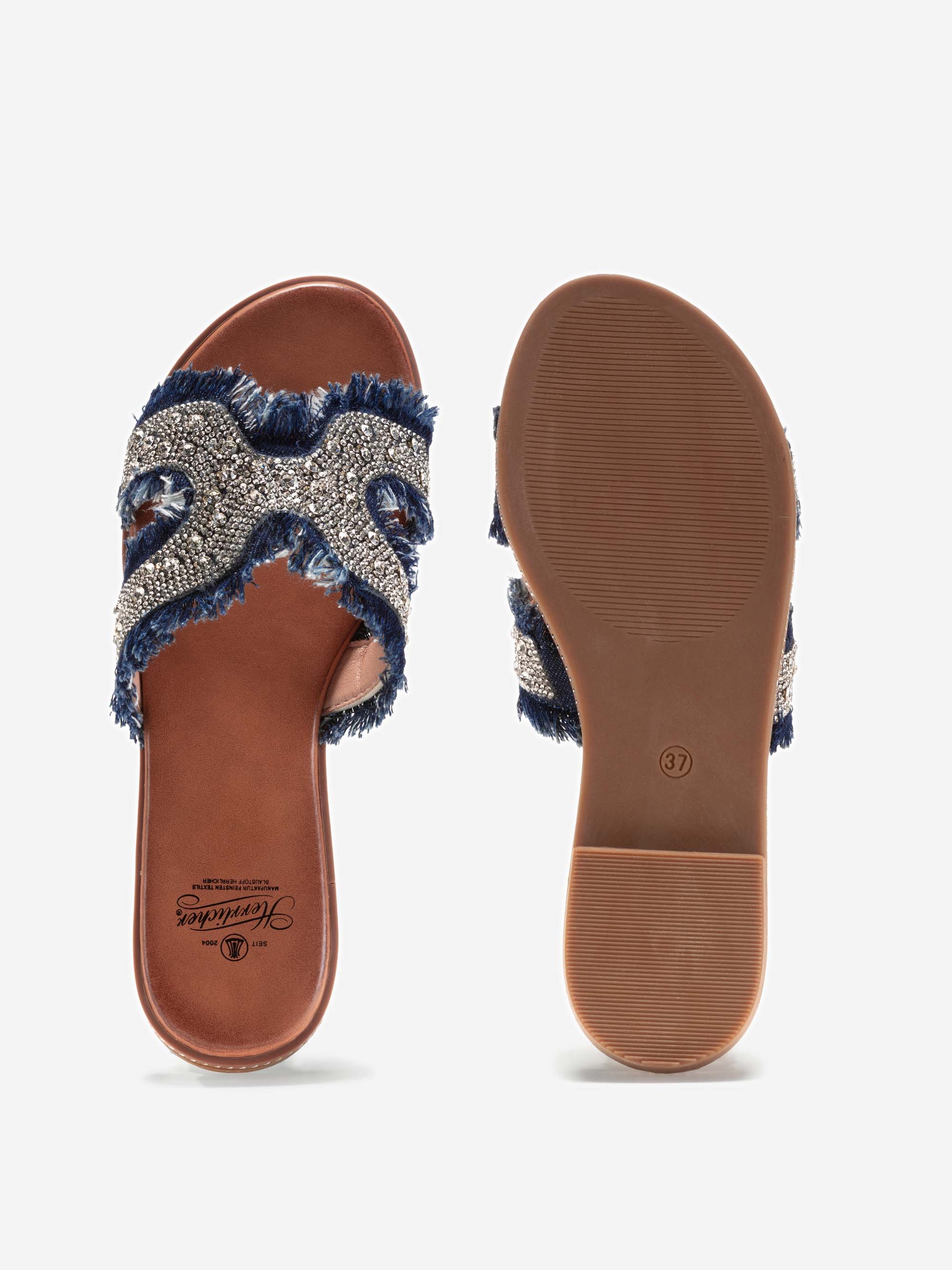 Ein Paar Damensandalen mit brauner Sohle und marineblauen Riemen mit Perlen und Fransen; eine Sandale zeigt die Draufsicht, die andere die Sohle mit einer Größenmarkierung.