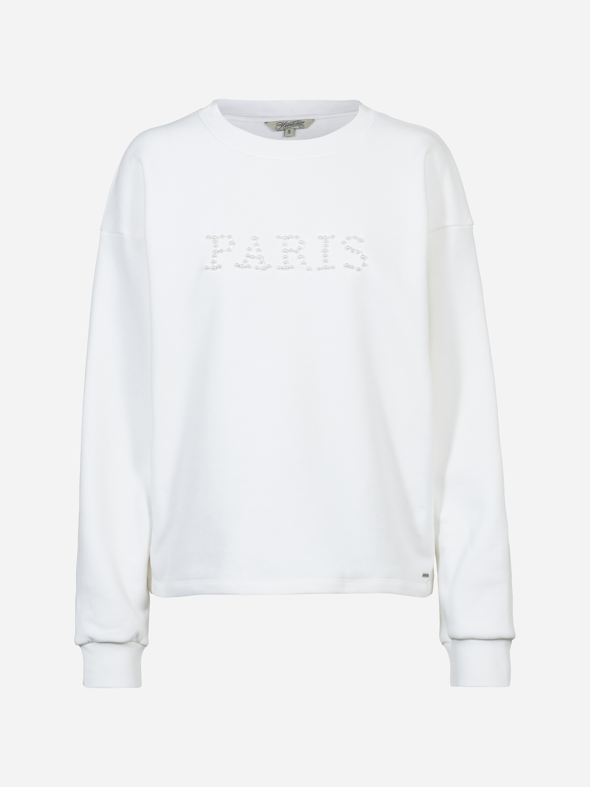 Ein schlichtes, weißes, langärmeliges Sweatshirt mit dem Wort PARIS, das mit perlenartigen Verzierungen auf der Brust geschrieben ist. Das Sweatshirt hat einen Rundhalsausschnitt und gerippte Bündchen und Saum.