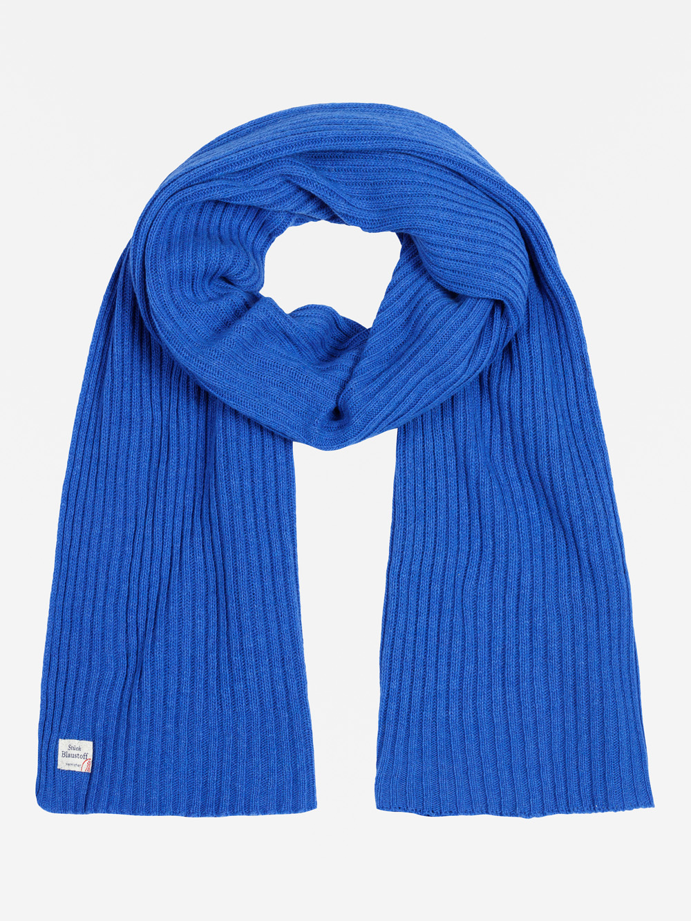 Ein hellblauer, gerippter Strickschal liegt flach vor einem weißen Hintergrund. Ein kleines weißes Etikett ist an einem Ende des Schals sichtbar.